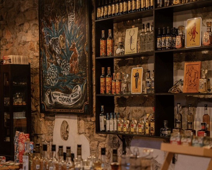 A bar with shelves of liquor bottles and a mural on the wall. 4