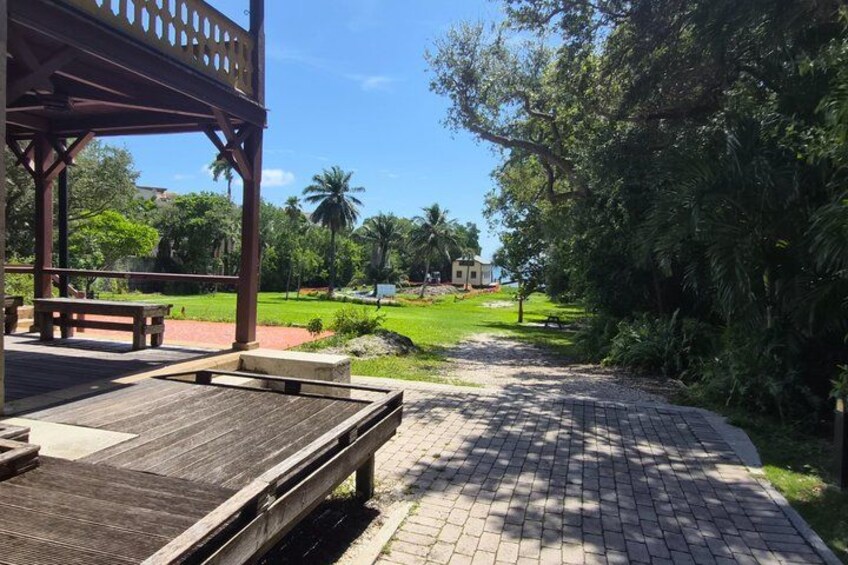 A wooden deck, a paved pathway, and lush greenery. 5