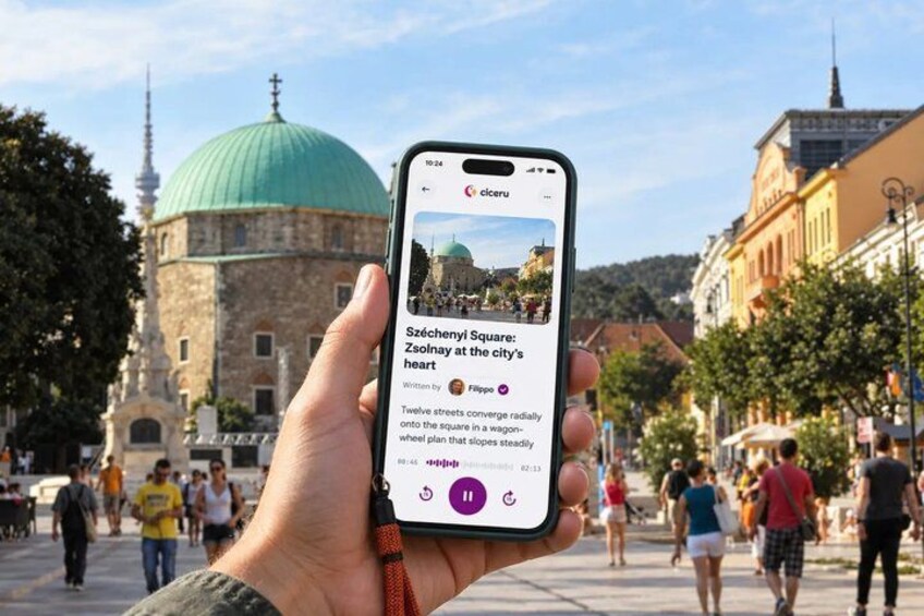A hand holding a smartphone displaying an article about Széchenyi Square. 2
