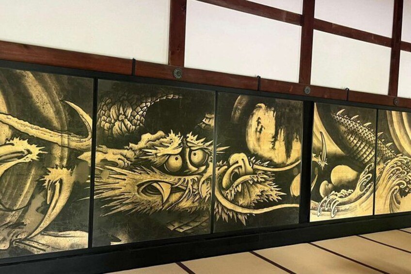 A series of traditional Japanese paintings on a wall. 5