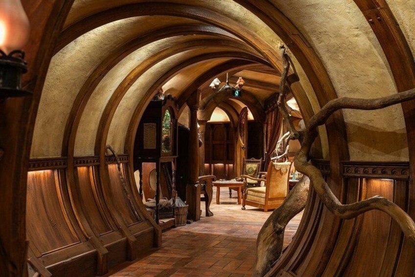 A wooden interior with arched ceilings and a central wooden structure. 4