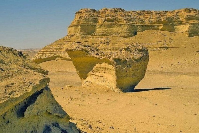 A desert landscape with a prominent rock formation. 4