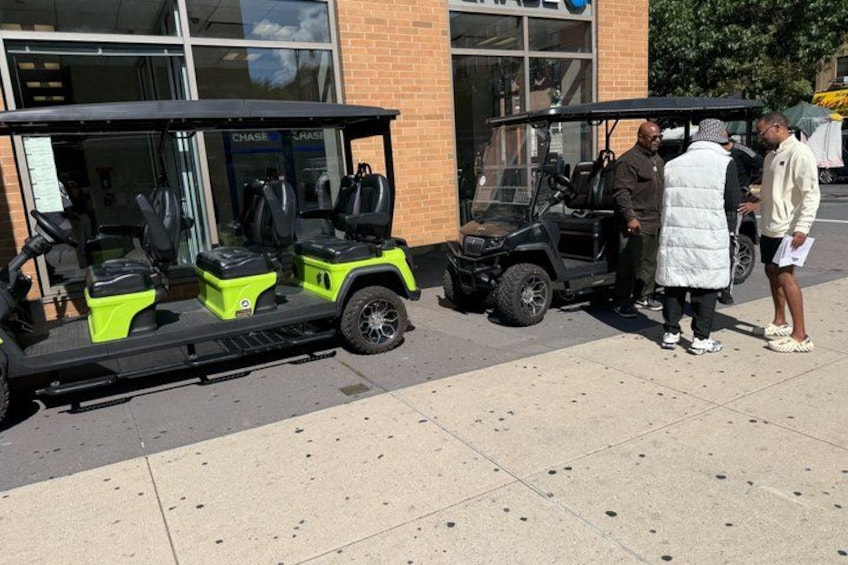 A golf cart parked in front of a building with a sign that reads 'CHASE.' 2