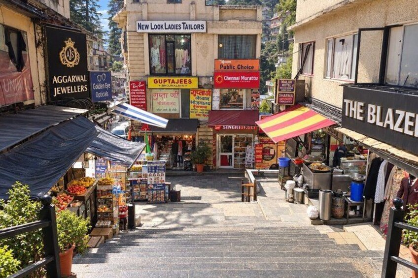 A street with shops, including a tailor and a jeweller. 3