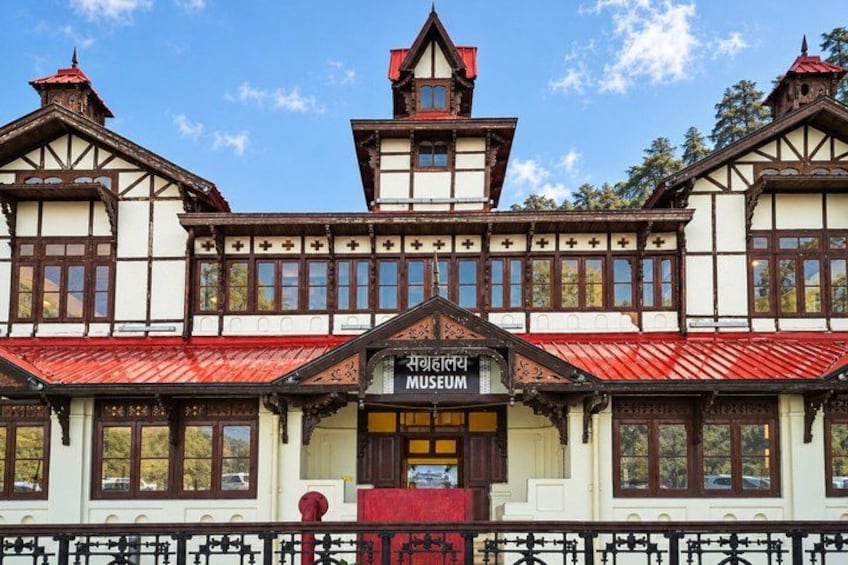 A museum with a traditional architectural style, featuring a prominent entrance and a red roof. 5