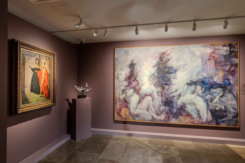 An art gallery with a classical painting and a large abstract painting. 5