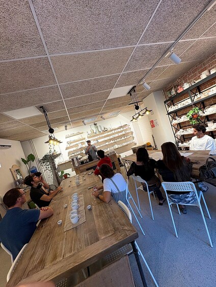 A cafe interior with tables, chairs, and a ceiling with a textured pattern. 3