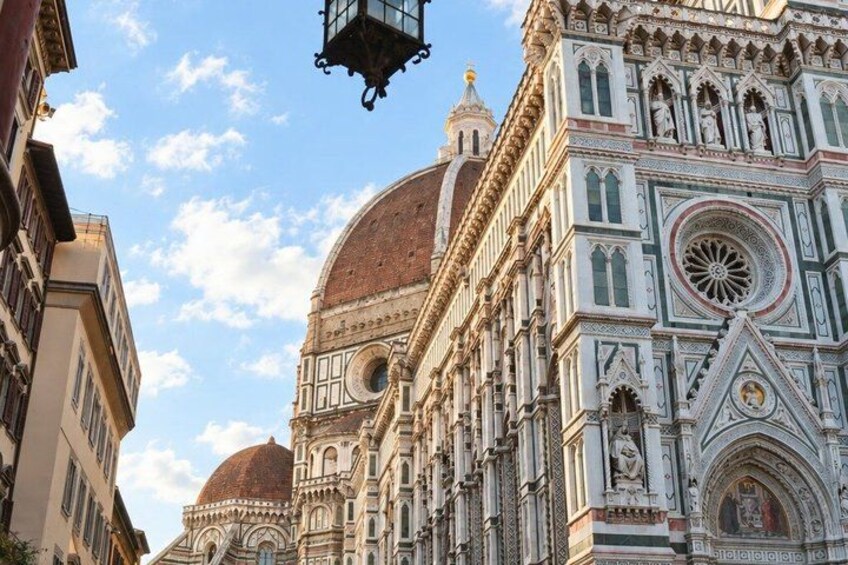 A historic building with ornate architecture, a dome, and a detailed facade. 1