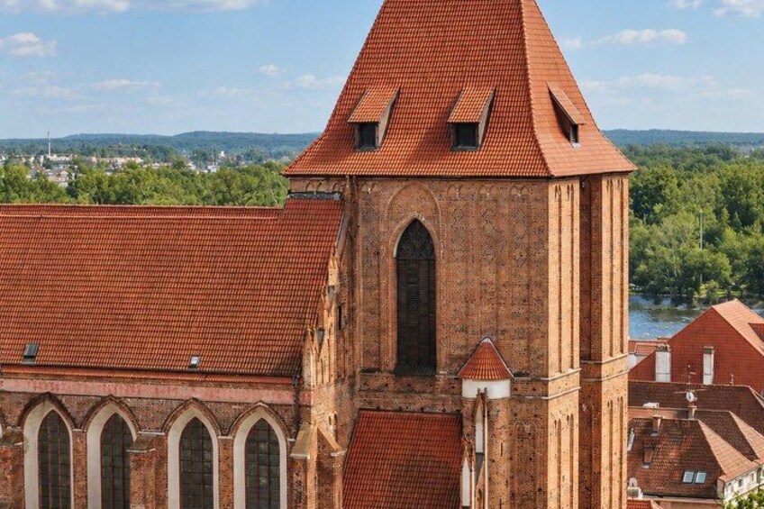 A church with a red-tiled roof and a tall tower. 3