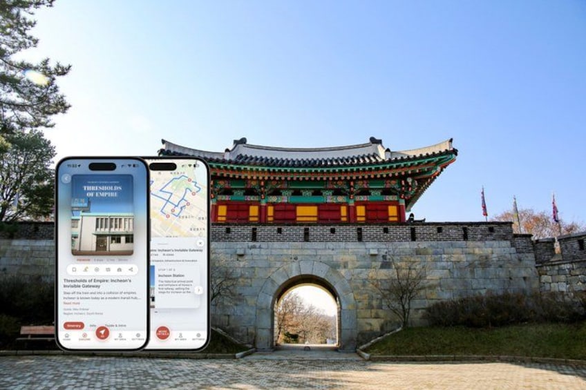 A traditional Korean gate with a smartphone displaying a map and information about the site. 1