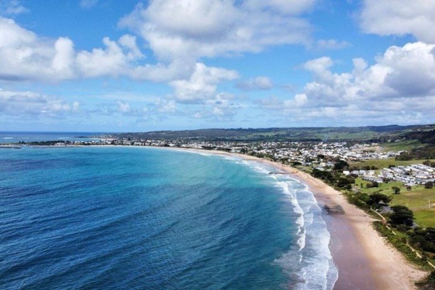 A coastal town with a beach, ocean, and residential area. 5