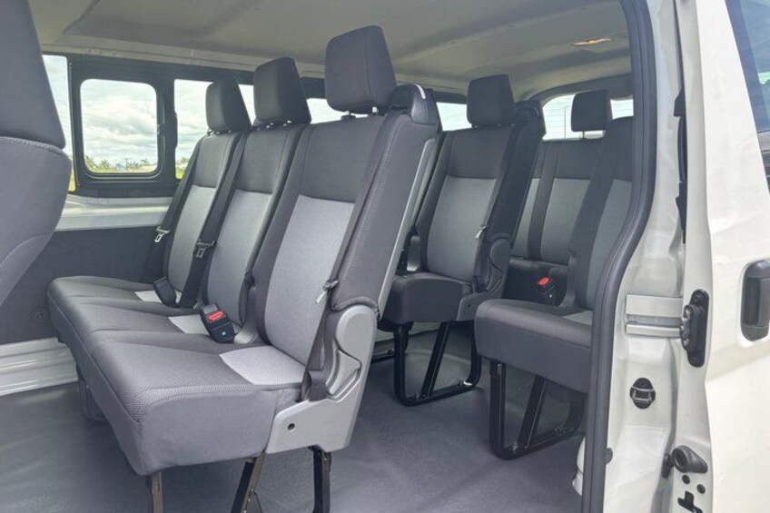 A white van with grey and black interior seating. 2