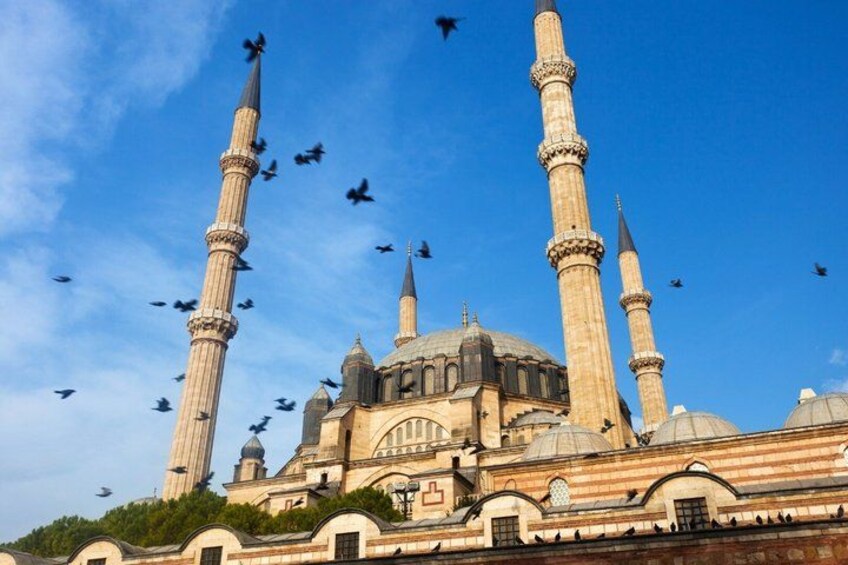 A mosque with two minarets and a dome. 1