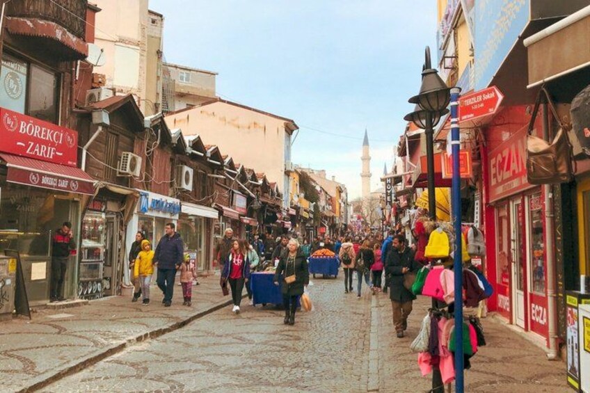 A bustling street with shops and pedestrians. 2