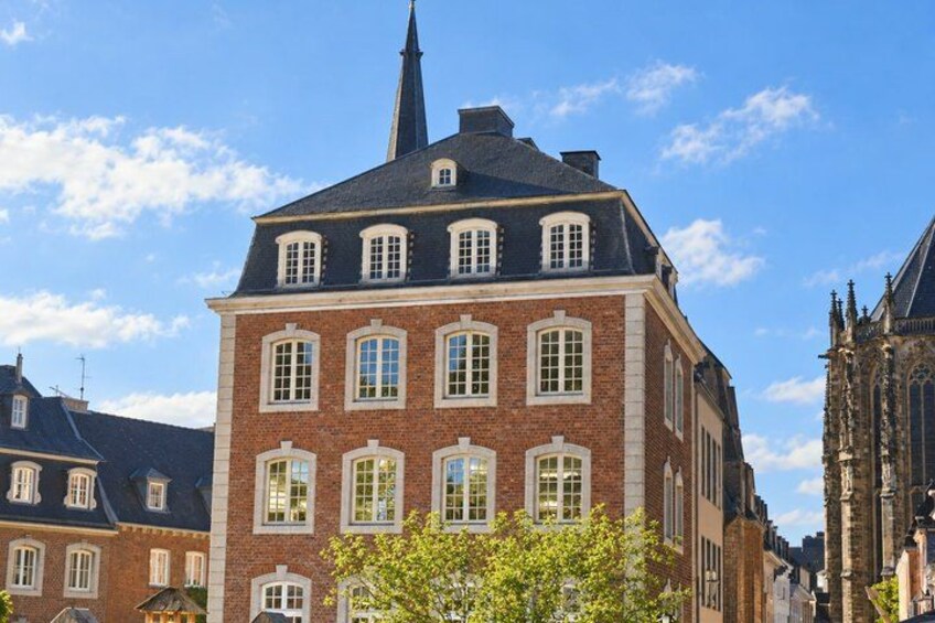 A historic building with a prominent tower and multiple windows. 4