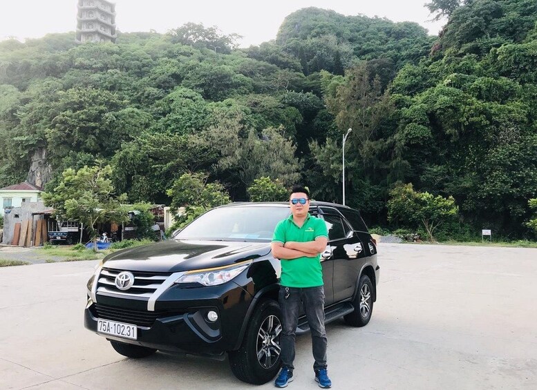 A black Toyota SUV parked in a parking lot with a person standing beside it. 4
