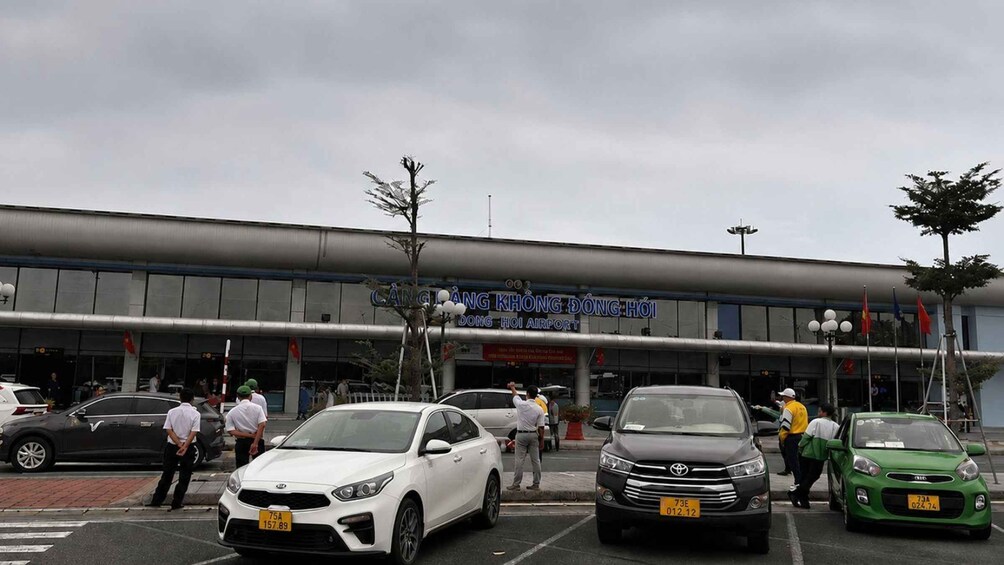 A building with a sign reading 'Cang Thang Khong Dong Hoi Airport'. 3