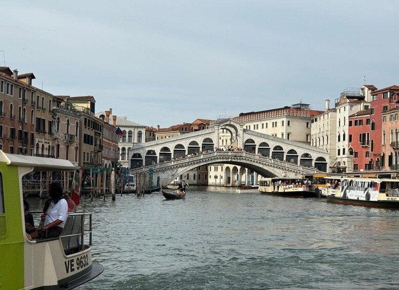 A historic bridge over a canal in Venice, surrounded by traditional Venetian buildings. 3