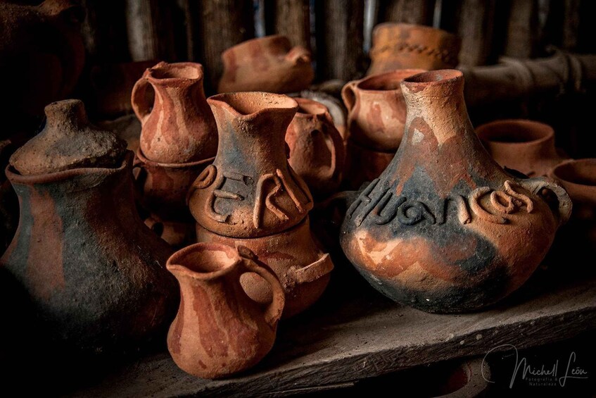 A collection of ancient pottery with inscriptions, displayed on a wooden surface. 2
