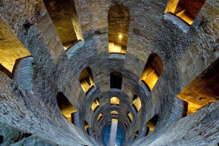 A spiral stone structure with multiple openings and a central shaft. 2