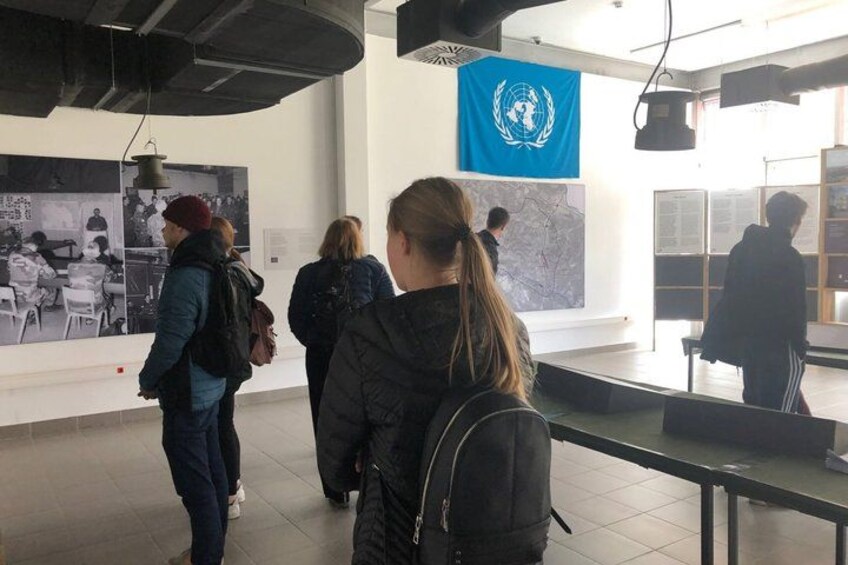 A group of people in a museum or gallery, observing exhibits. 5