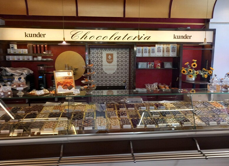 A chocolate shop with a display of assorted chocolates and a sign that reads 'Chocolateria.' 2