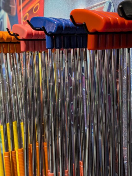 A collection of paintbrushes with various colored handles. 3