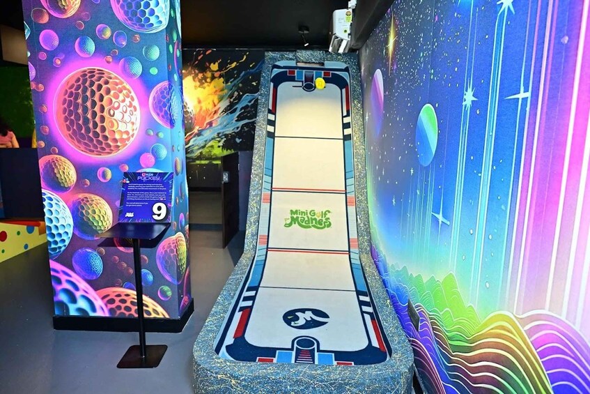 A bowling alley with a vibrant, space-themed mural on the walls. 1