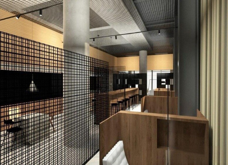 A modern interior with a grid-like partition, wooden seating, and a large pillar. 5