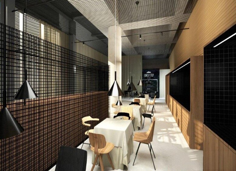 A modern interior with tables and chairs, a blackboard, and a grid-patterned wall. 4