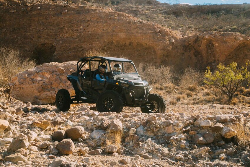 A Polaris off-road vehicle navigating a rocky terrain. 3