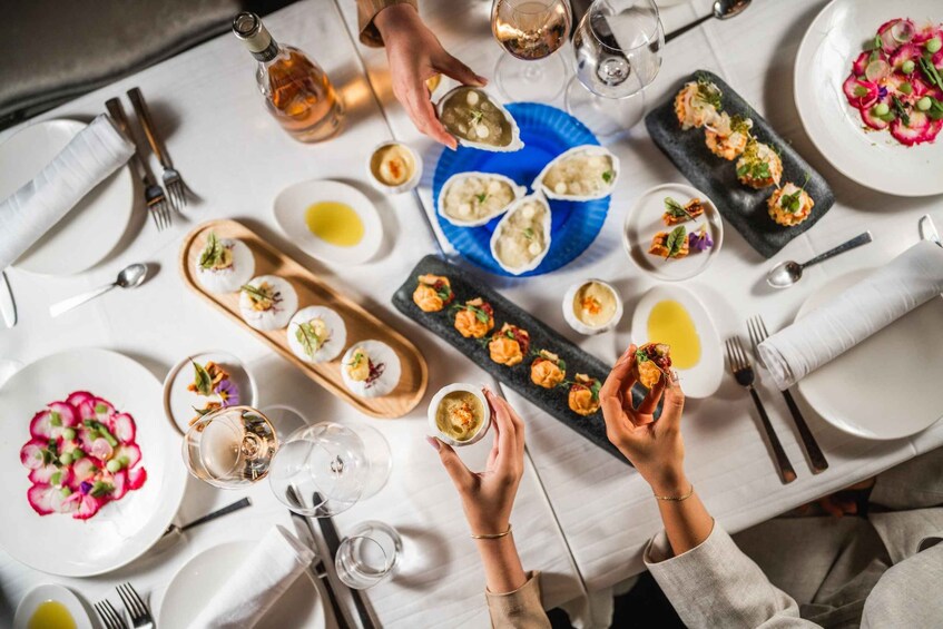 A dining table with various dishes, glasses, and utensils. 1