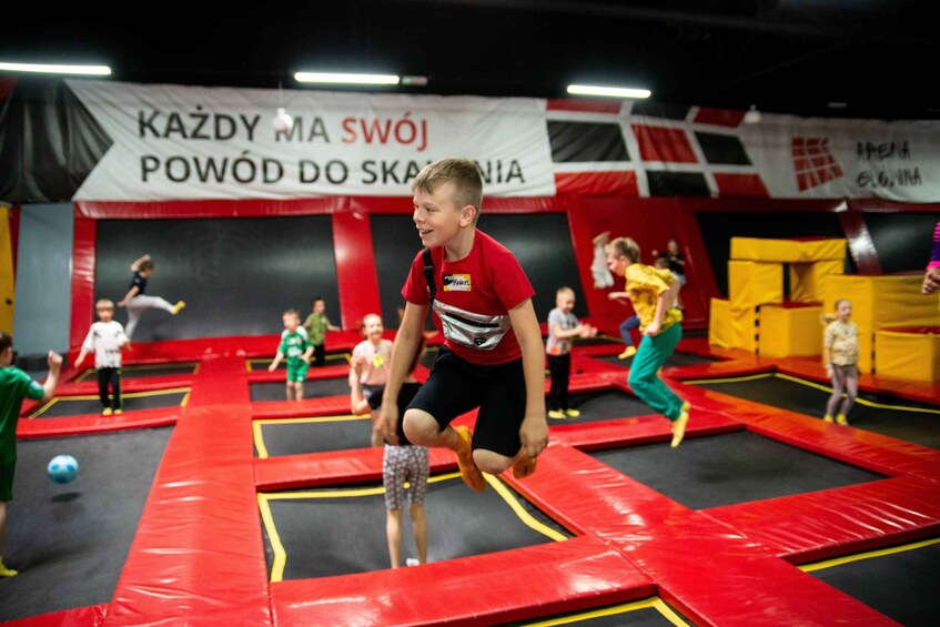 A trampoline park with children jumping and playing. 1