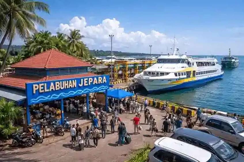 A busy port with a ferry, people, and a sign reading 'PELABUHAN JEPARA'. 4