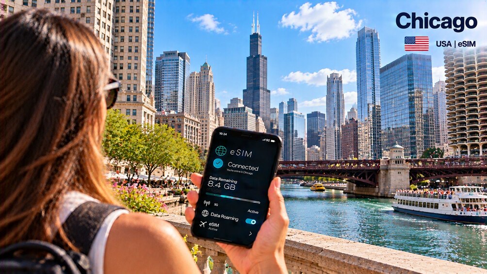 A person holding a smartphone with a cityscape in the background. 5