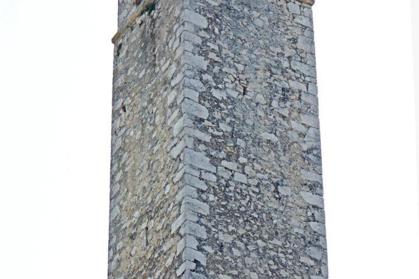 A section of a stone wall with irregularly shaped stones and a rough texture. 4