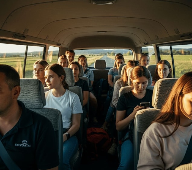 A vehicle interior with passengers seated and looking out the windows. 2