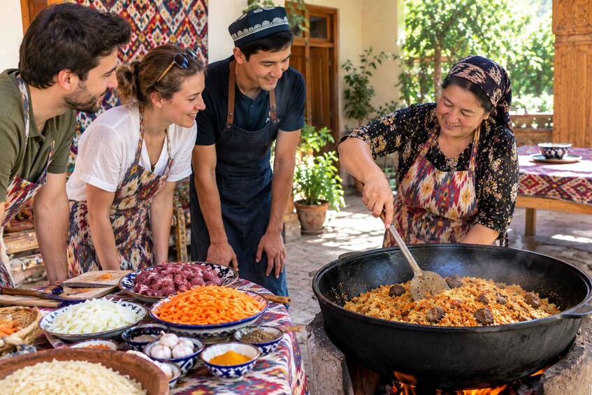A group of people cooking outdoors with a large wok on a fire, surrounded by various ingredients and dishes. 1