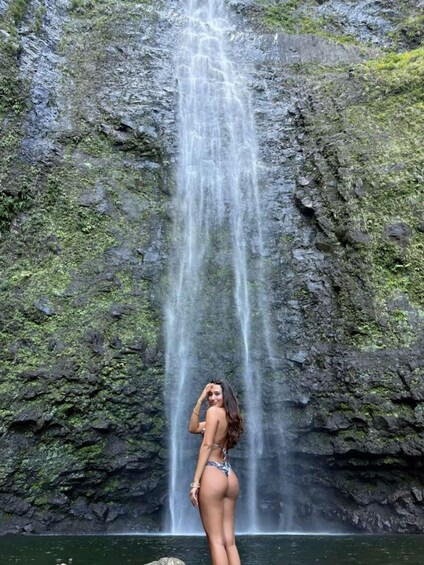 A waterfall cascading down a rocky cliff with lush greenery. 4