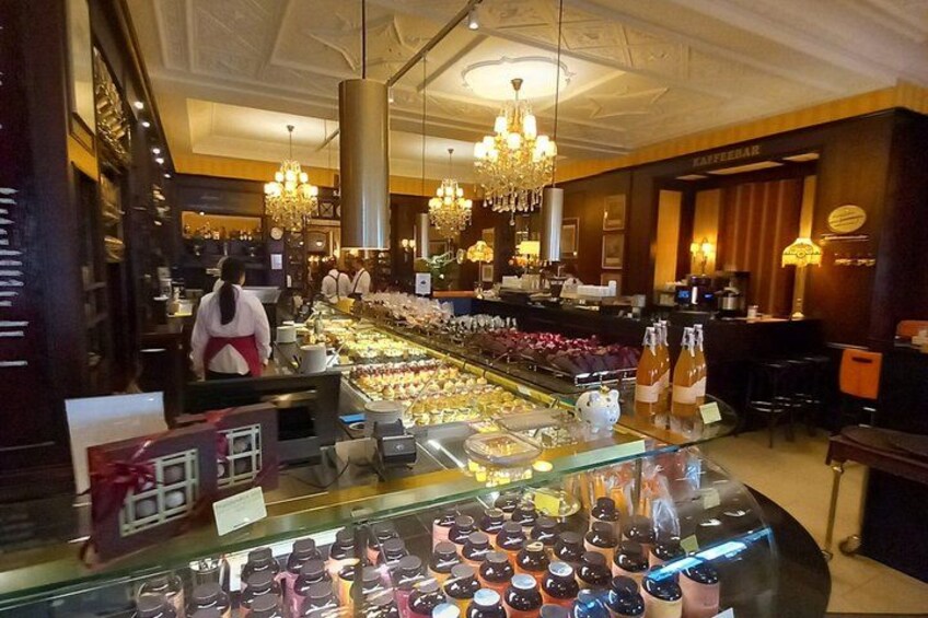 A bakery display with pastries and a counter. 1