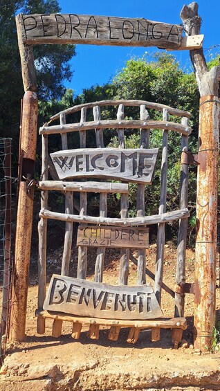 A rustic wooden sign with the words 'WELCOME' and 'CHILDREN' carved into it. 2