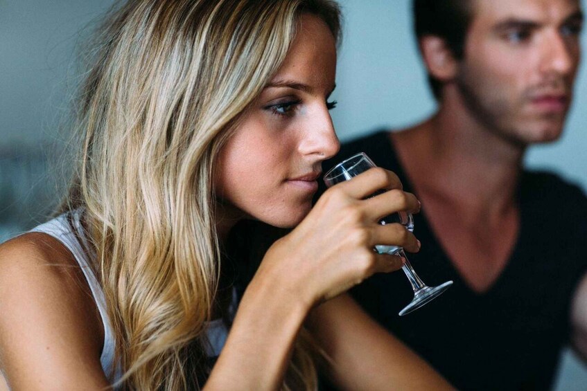 A person holding a glass. 5