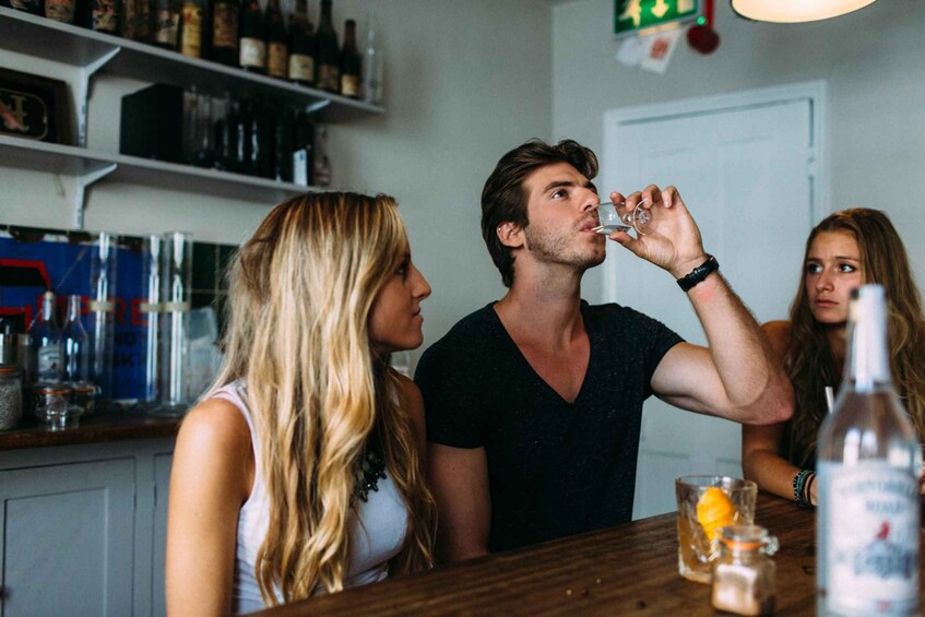 A bar setting with bottles and glasses on the counter. 1