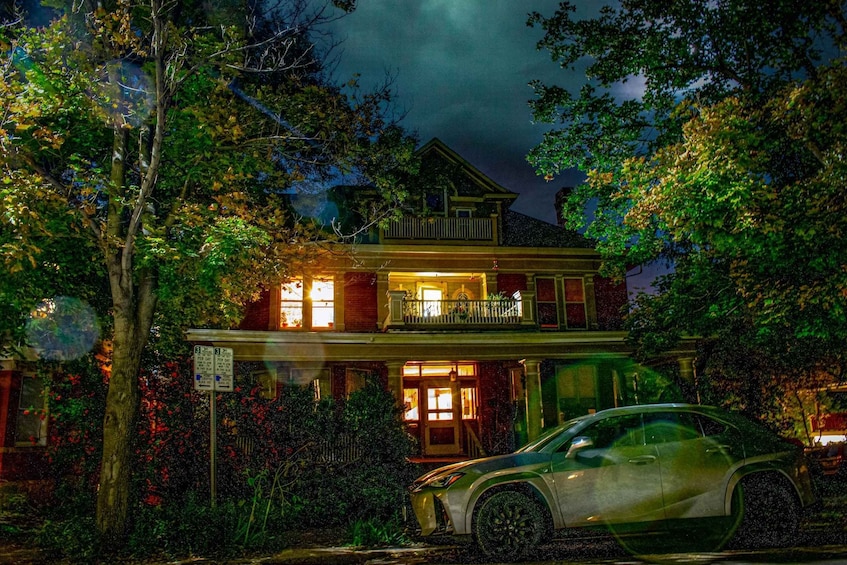 A two-story house with a car parked in front. 5