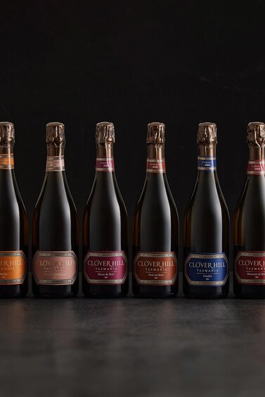 Six bottles of wine with labels indicating they are from Tasmania. 2