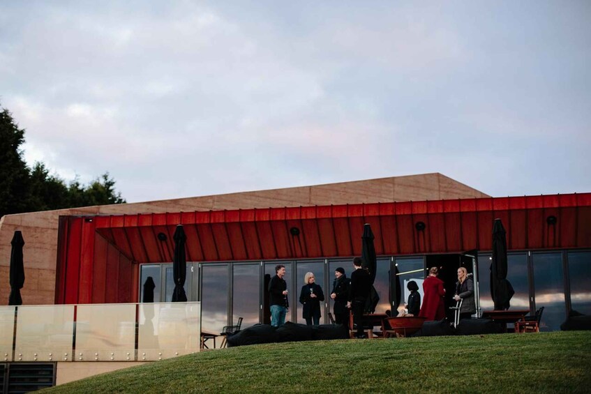 A modern building with a red roof and glass facade. 4