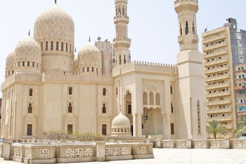 A large, ornate building with multiple domes and minarets, surrounded by a courtyard with decorative patterns. 4