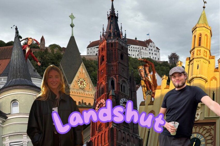 Two people in front of historic European architecture, including a clock tower and a church. 1