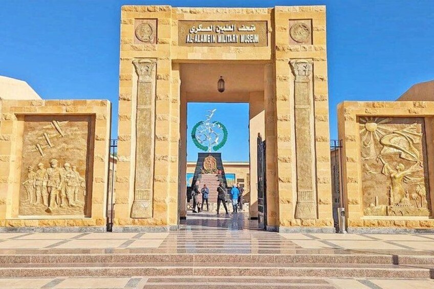 The entrance to the Al-Ain Military Museum with a large archway and relief sculptures. 1