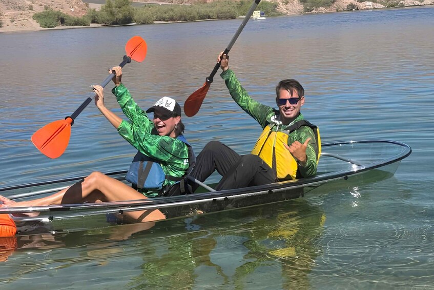 Two people in a canoe on a calm body of water. 3